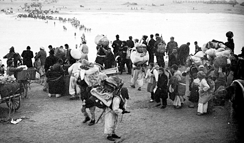 Displaced South Koreans carrying their most prized possessions fled the North Korean Peoples Army (NKPA) to seek refuge in the Pusan Perimeter.
