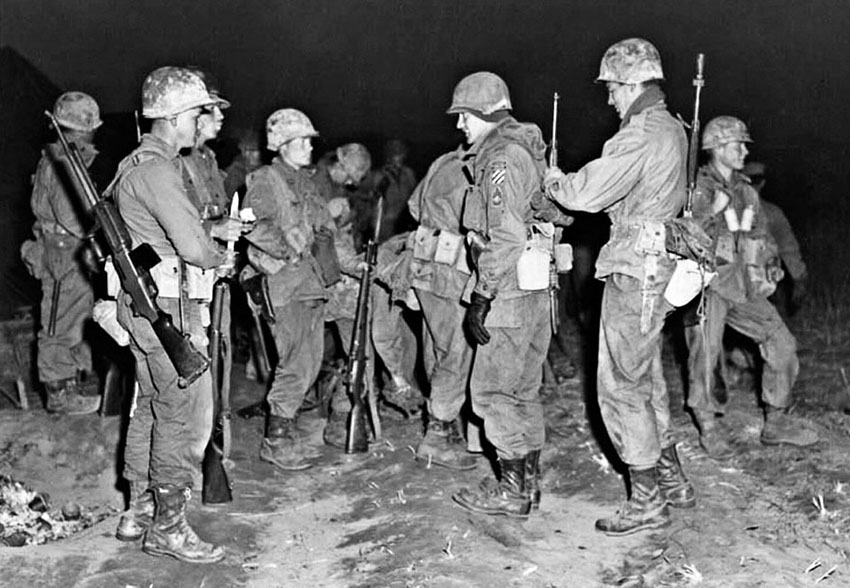 Men of the 3rd Ranger Company prepare for a night patrol north of the Imjin River in April 1951.