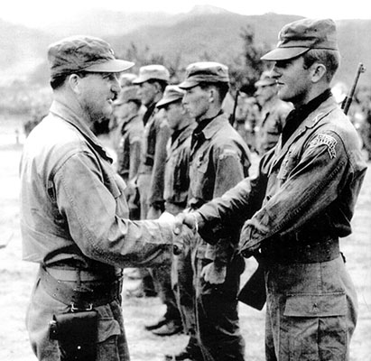 1st Lieutenant Andrew J. Adams receives the Silver Star from Brigadier General George C. Stewart, Assistant Division Commander, 2nd Infantry Division.