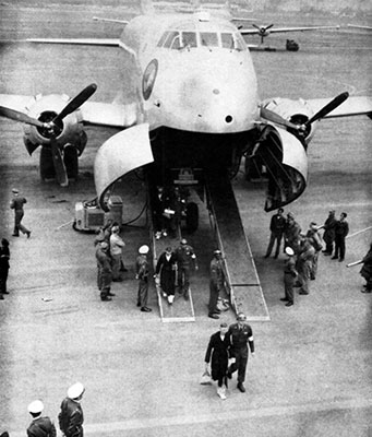 Former U.S. POWs are escorted down the ramp of the Air Force C-124 that brought them to Tokyo, Japan. Those POWs in need of significant medical treatment were flown to Japan before travelling on to the United States.