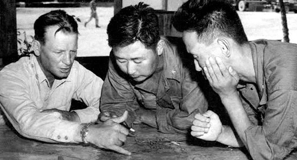 BG Paik Sun-yup (center) reviews dispositions with his American KMAG (Korea Military Advisory Group) advisor.
