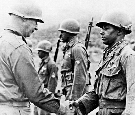 Major General Claude B. Ferenbaugh, Commanding General of the 7th Infantry Division, awards the Silver Star to Corporal Anthony Andrade.