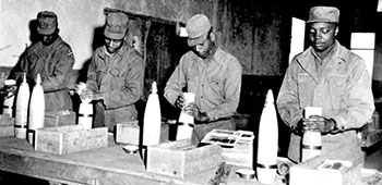 Leaflet rolls being loaded into 105mm BE Smoke shells at the EUSAK Ammunition Supply Point prior to being shipped to Corps artillery units.