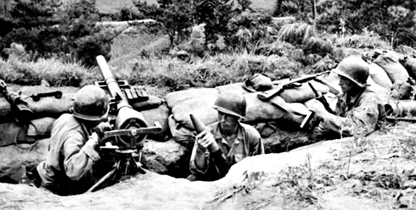 American soldiers ready a 75 mm recoilless rifle as they man an improvised position in South Korea while trying to stem the Communist advance, 31 July 1950.