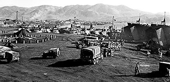 A truck convoy approaches the beach landing sites at Hungnam.