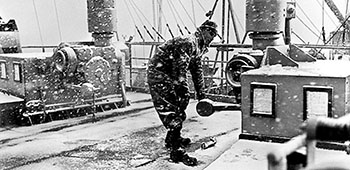 Operating a winch in a snowstorm off Hungnam in December 1950.