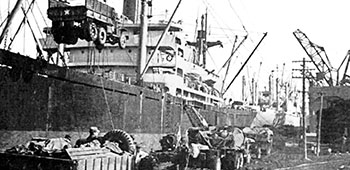 One of 1,400 USMC vehicles is swung aboard a merchant ship at Hungnam dock on 14 December 1950. Some transports made two and three round trips before the evacuation was completed.