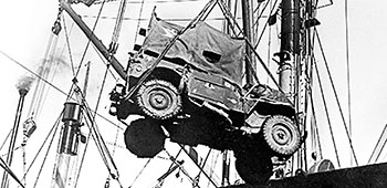 A U.S. Marine Corps’ ambulance jeep is hoisted aboard ship at Hungnam, North Korea, 12 December 1950.
