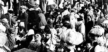 Some of the 14,000+ panic-stricken North Korean refugees stand shoulder to shoulder on the main decks of the SS <i>Meredith Victory</i> - December 24, 1950.