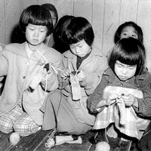 Children at an orphanage learn to knit with items donated through UNCACK channels. In an effort to stem corruption and waste, UNCACK became the lead agency that monitored the flow of supplies to orphanages.