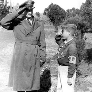 The unprecedented refugee situation required a herculean effort to take care of the homeless and orphaned. Here Colonel Frank Norwood, 61st Troop Carrier Group, salutes an “honor guard” from an orphanage on Cheju-do. UNCACK was heavily involved in supporting Korean orphanages as part of its Civil Assistance mission.