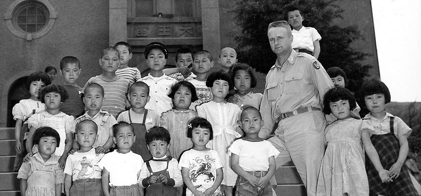 An American officer poses with children at the Catholic-run Our Sweet Home Orphanage in 1952. U.S. soldiers still sponsor orphanages in South Korea.