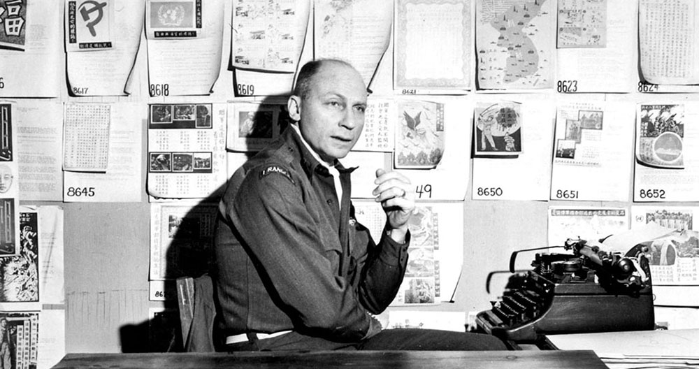 CPT Avedon sits at his desk in the 1st L&L. Notice the Psywar leaflets posted to the wall behind him, as well as the 1st Ranger Battalion scroll on his shoulder.