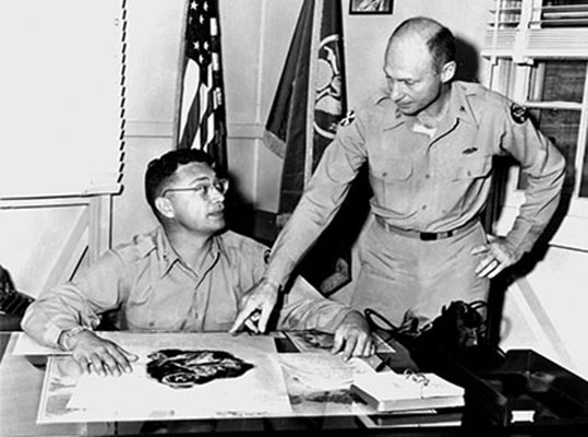 CPT Avedon discusses a Psywar leaflet at the 14th Radio Broadcasting and Leaflet Battalion, Fort Shafter, HI, 1955.