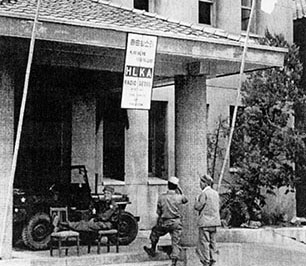 1LT Robert B. Shall, Radio Officer for the Radio Seoul detachment, sits outside the entrance of HLKA.