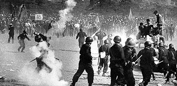In the midst of tear gas Japanese police break ranks to attack rioters on an American car. “As soon as a tear gas canister was thrown into the midst of rioters, it was plucked up and hurled back at the police,” said Peter Lee, 1st RB&L veteran.