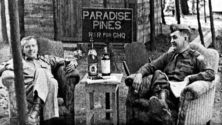 1LT Arthur E. Holch, 1st RB&L Radio News Operations, and CPT Frederick P. Laffey, 4th MRBC Radio Manager, relax in ‘Paradise Pines’ during a field visit to <i>Radio Pusan</i>.