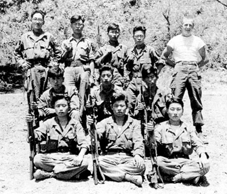 SGT Robert W. Morgan, 1st Ranger Company, poses with ten ROKA students during the X Corps Guerrilla Operations & Sabotage course.
