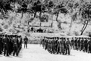 The South Korean Minister of Defense addressed and reviewed the 300-man CIA guerrilla force and Special Mission Group (45 personnel) during a visit to the island in late spring 1952.
