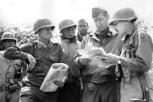 (L-R): BG Frederick, FSSF; LTG Mark Clark, Fifth Army commander; BG Donald Brann, Fifth Army G-3; and MG Geoffrey Keyes, II Corps commanding general, study a map on the outskirts of Rome on 4 June 1944.