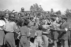 Radcliffe’s patrol is greeted by cheering Romans. Radcliffe is the soldier in the passenger’s seat of the jeep.