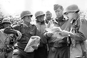(L-R): BG Robert Frederick, FSSF; LTG Mark Clark, Fifth Army commander; BG Donald Brann, Fifth Army G-3; and MG Geoffrey Keyes, II Corps commanding general, study a map on the outskirts of Rome on 4 June 1944.
