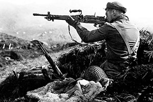 A Forceman in an abandoned Japanese defensive position on Kiska aims a Type 96 light machinegun. The hurried Japanese evacuation meant a wealth of souvenirs for the occupying troops.