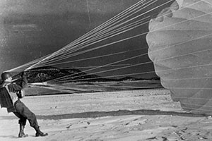 CPT Carl A. Brakel takes off his parachute after first jump.