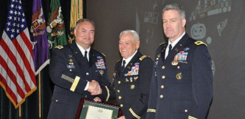 In 2013, Colonel Retired Fry was chosen as a Distinguished Member of the Special Forces Regiment. Major General Edward M. Reeder, Jr. presents the framed certificate. 
