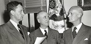 State Department Chief of Protocol Stanley Woodward, Sr. administers the oath of office to Hilldring for service as the Assistant Secretary of State for Occupied Areas in the Department of State, 1946.