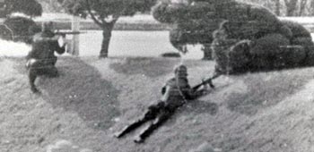 In November 1984, a Soviet Defector ran across the MDL requesting asylum, and an intense forty-minute firefight followed. Lamb, left kneeling, led his squad reaction force against North Korean soldiers in the “sunken garden.” He later stated, “We closed to within ten or fifteen meters and forced them to raise their hands above their heads and surrender.”
