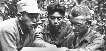 BG Frank D. Merrill, Commander, 5307th Composite Unit (Provisional), talks with Kachin Scouts.