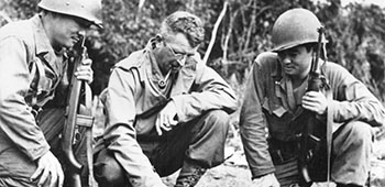 BG Frank D. Merrill explains battle situation to L. Herb Miyazaki and R. Akiji Yoshimura, interpreters for 3rd Battalion 5307th, Burma, 1944.