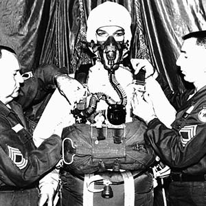 SGTs Johnson and McCarron of the Aerial Delivery Equipment Division, US Army Natick Laboratories, checks the oxygen and harness of the HALO (High Altitude Low Opening) parachute assembly.