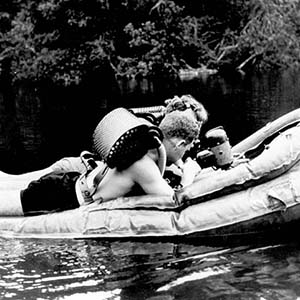 GM2C Norm Wicker, USN, and GM2C John Spence, USN  on prototype of the silent electric surfboard wearing LARU MK II.