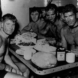 On board USS Burrfish before Gagil Tomil Island Mission, 18 August 1944. Recon Team during pre-mission equipment check.