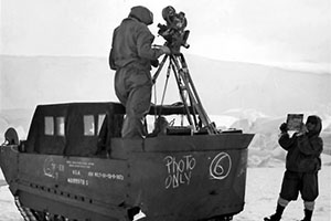 U.S. Navy photographers make a motion picture from a M29 Weasel in Antarctica during Operation Highjump.